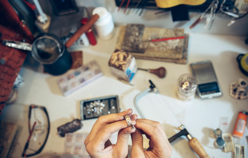 different goldsmiths tools on the jewelry workplace. jeweler at work in jewelry.