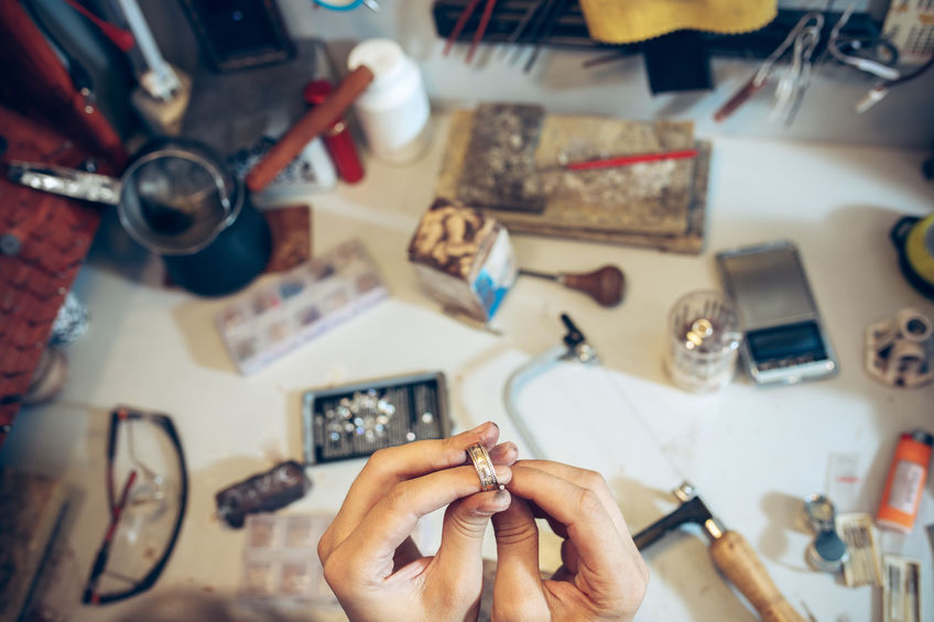 different goldsmiths tools on the jewelry workplace. jeweler at work in jewelry.